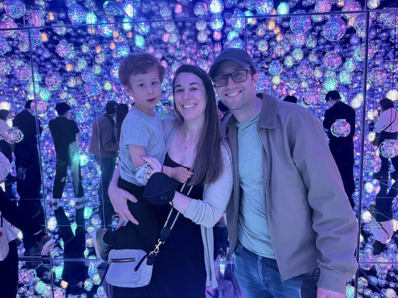 The family in Teamlab Borderless, surrounded by glowing lights